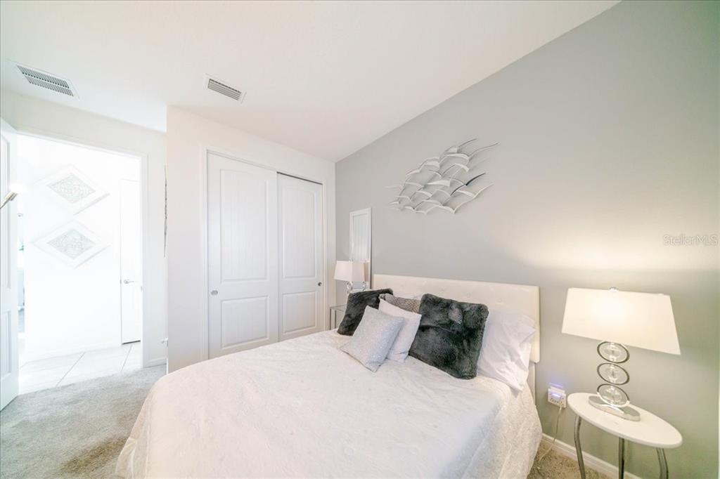 1833 Spring Shower Circle Kissimmee, FL 34744 - Photo 37 of 51 a bedroom with a bed and a lamp