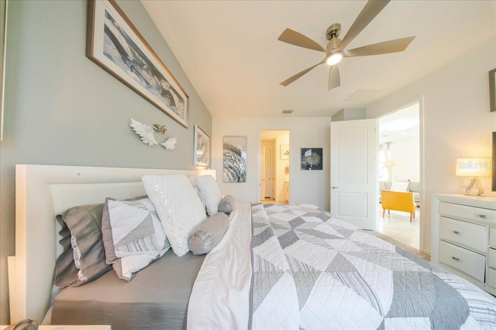 1833 Spring Shower Circle Kissimmee, FL 34744 - Photo 40 of 51 a bedroom with a bed and a chandelier