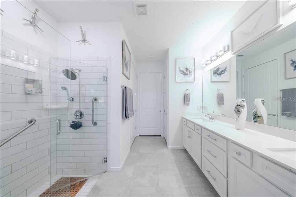 1833 Spring Shower Circle Kissimmee, FL 34744 - Photo 42 of 51 a spacious bathroom with a double vanity sink mirror and shower