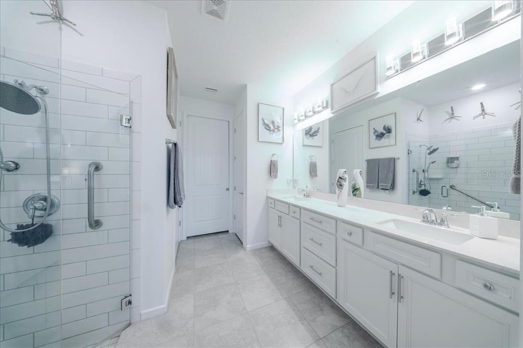 1833 Spring Shower Circle Kissimmee, FL 34744 - Photo 43 of 51 a spacious bathroom with a shower sink and mirror