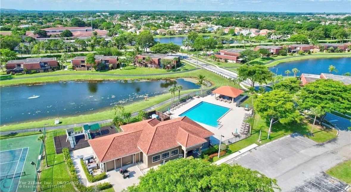 8282 Boca Rio Drive Boca Raton, FL 33433 - Photo 25 of 29 an aerial view of a house with a lake view