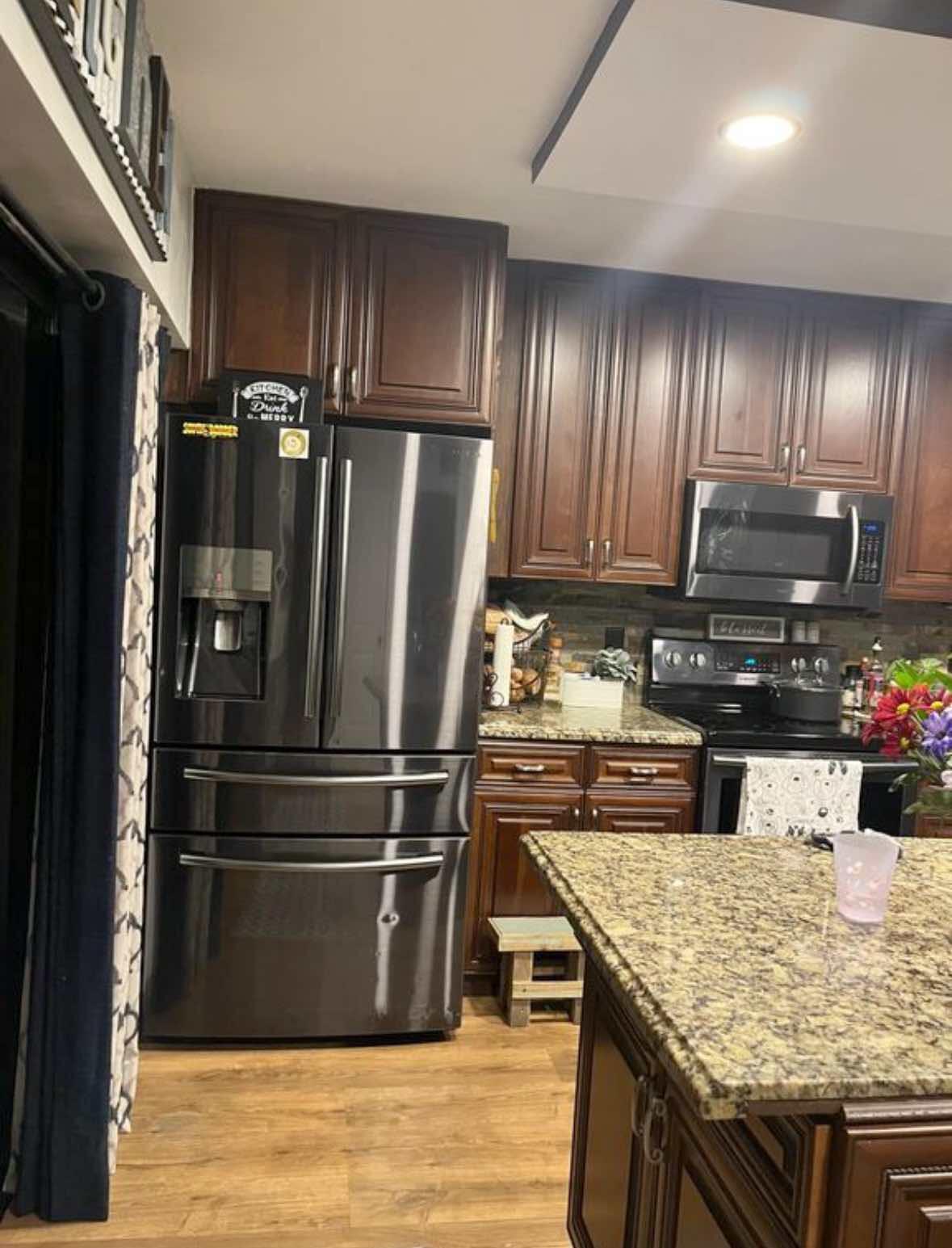 8282 Boca Rio Drive Boca Raton, FL 33433 - Photo 8 of 29 a kitchen with kitchen island wooden cabinets and stainless steel appliances
