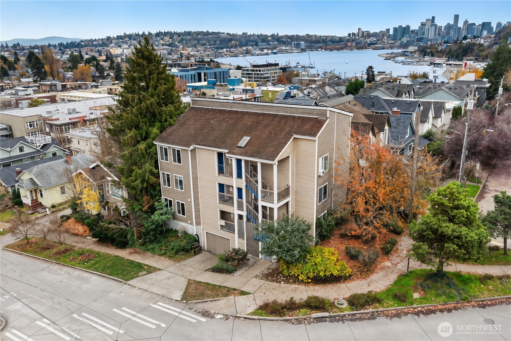 a aerial view of a house with a yard and lake view