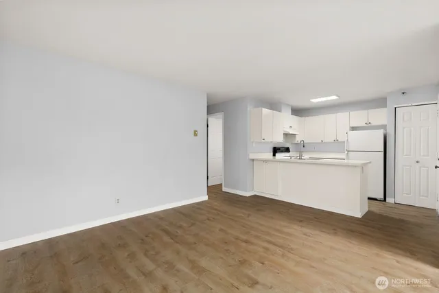 a kitchen with cabinets appliances and a sink