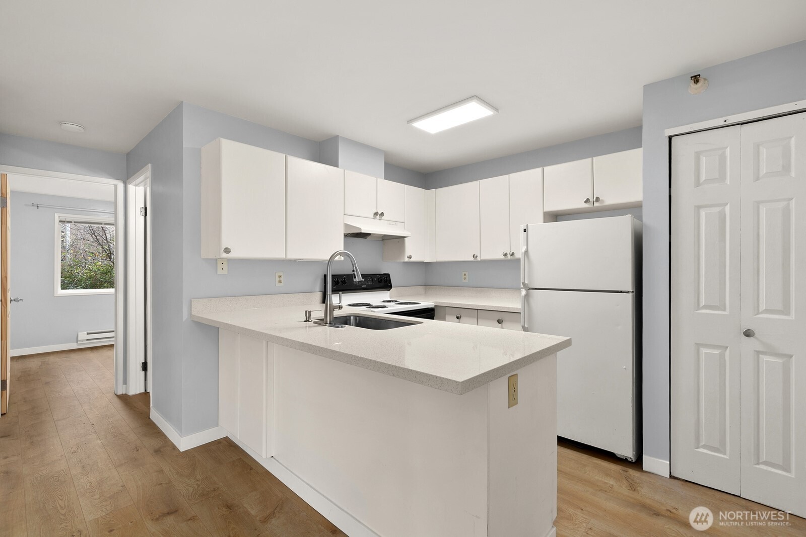 3660 Whitman Avenue North Seattle, WA 98103 - Photo 15 of 40 a kitchen with a white refrigerator a sink and cabinets