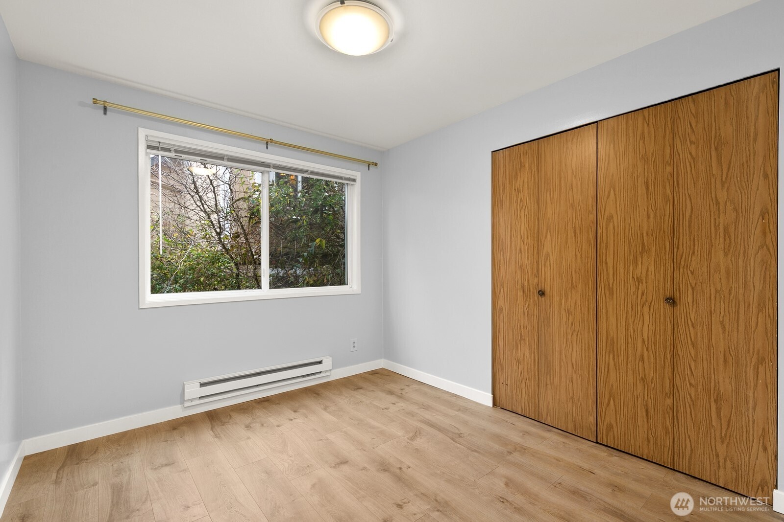 3660 Whitman Avenue North Seattle, WA 98103 - Photo 16 of 40 a view of an empty room with wooden floor and a window