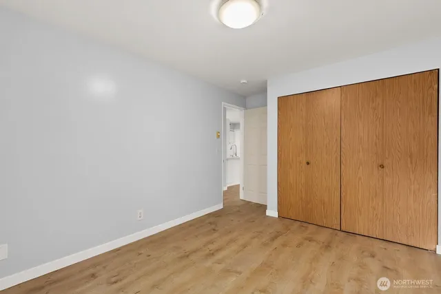 a bathroom with a granite countertop sink toilet and a mirror