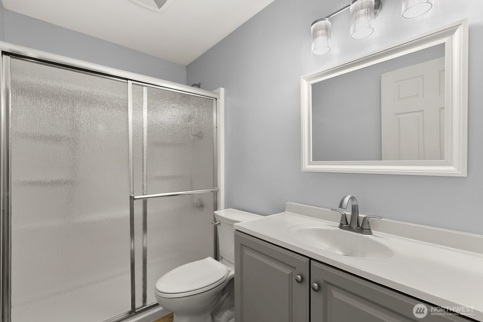 3660 Whitman Avenue North Seattle, WA 98103 - Photo 19 of 40 a bathroom with a granite countertop sink toilet and a mirror