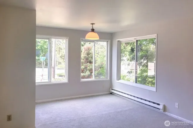 a view of a livingroom with wooden floor and staircase