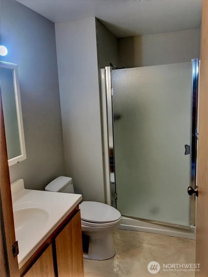 3660 Whitman Avenue North Seattle, WA 98103 - Photo 29 of 40 a white toilet sitting next to a bathroom sink