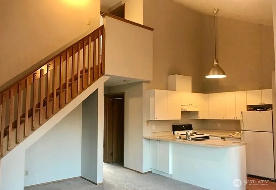 3660 Whitman Avenue North Seattle, WA 98103 - Photo 32 of 40 a kitchen with appliances a stove and a refrigerator