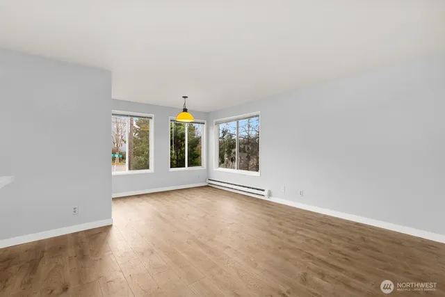 a view of kitchen with wooden floor and window