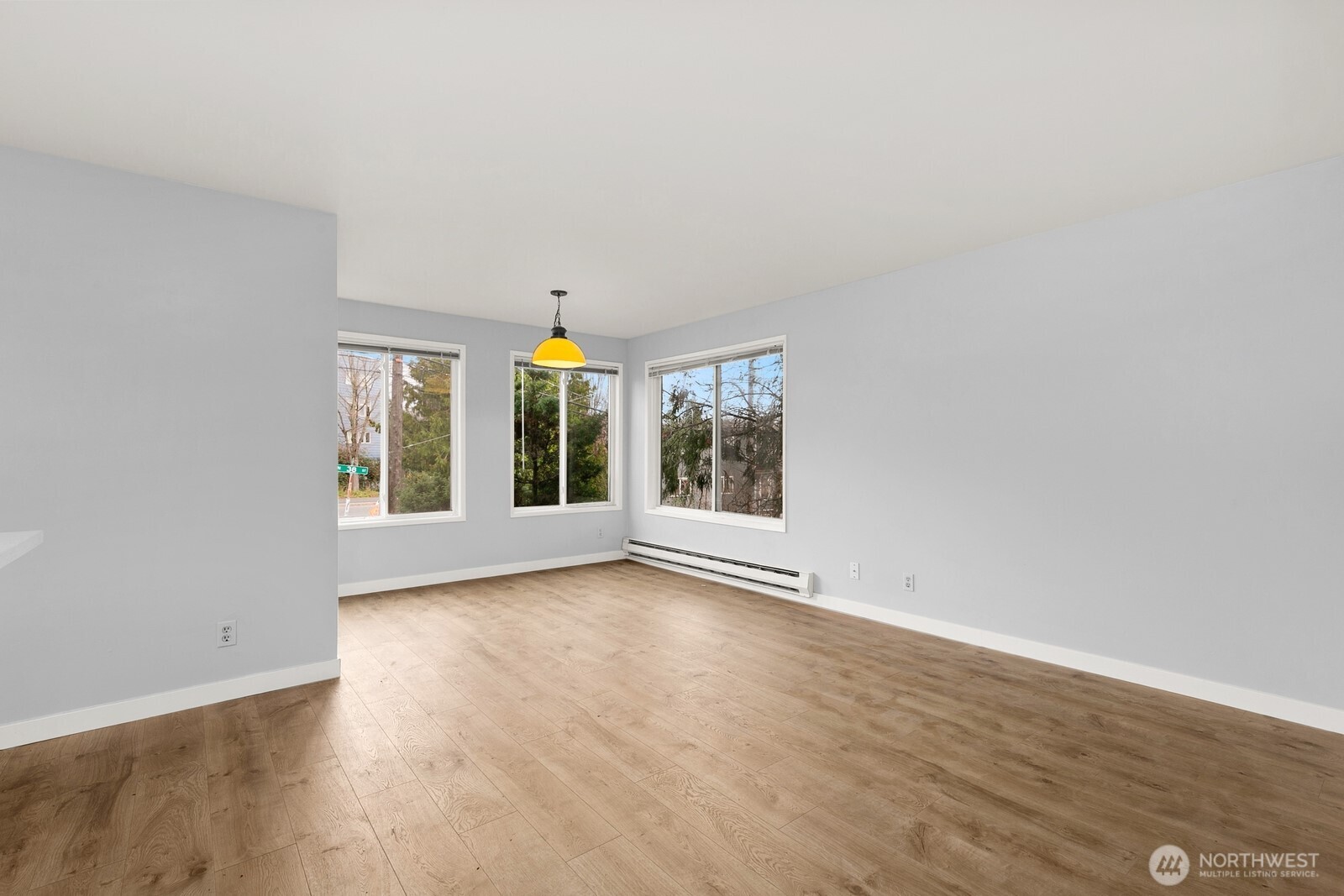 3660 Whitman Avenue North Seattle, WA 98103 - Photo 7 of 40 an empty room with wooden floor and windows