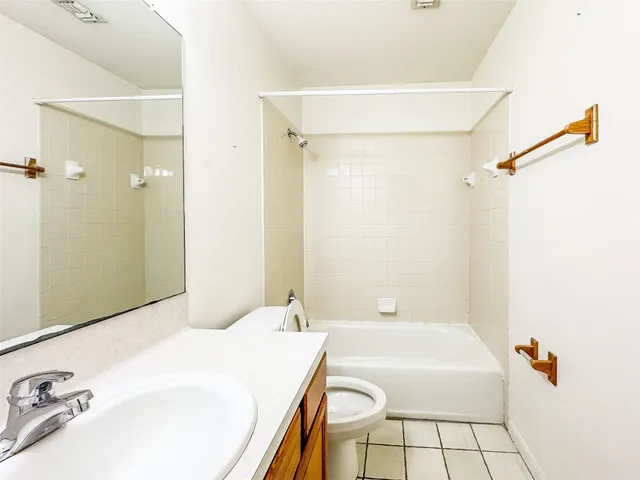 a bathroom with a tub a sink and glass door