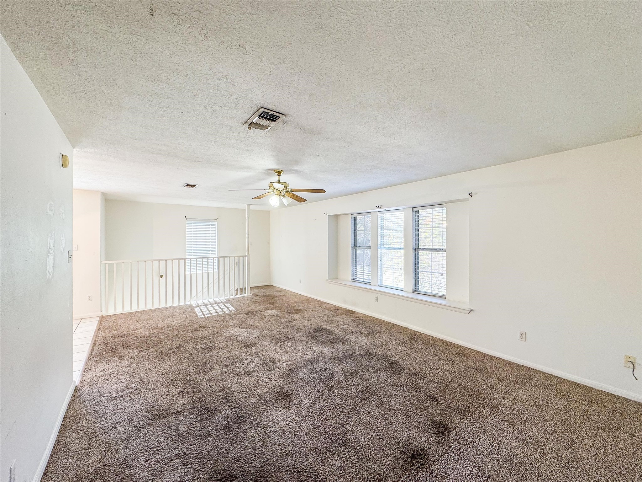 2006 Kilgore Road, Unit 101 Baytown, TX 77520 - Photo 4 of 20 an empty room with windows and chandelier fan