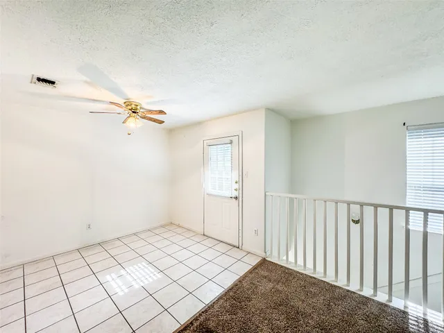 a view of a room with a window and hardwood floor