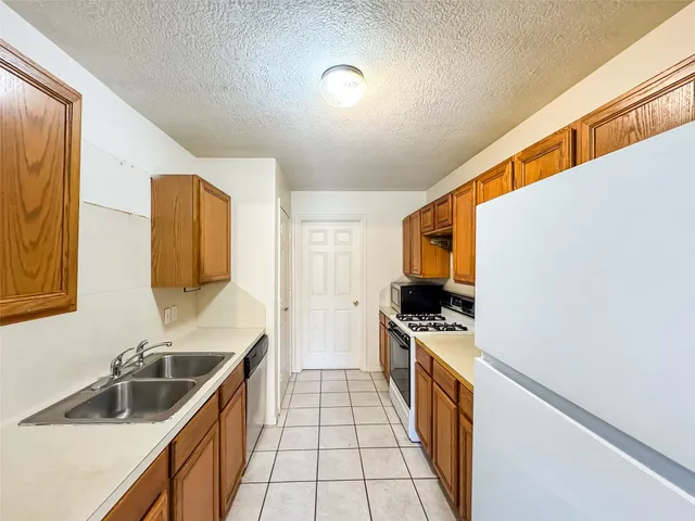 a kitchen with a sink and a stove top oven