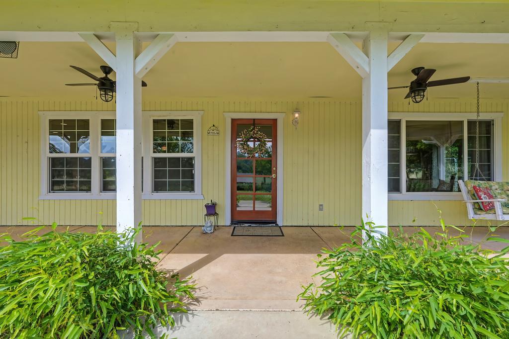 6181 Lambert Lane El Dorado, CA 95623 - Photo 14 of 68 view of exterior entry featuring ceiling fan and covered porch