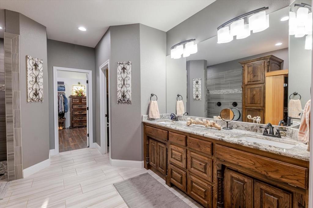 10106 Prather Road Springtown, TX 76082 - Photo 15 of 40 a spacious bathroom with a granite countertop sink mirror and a shower