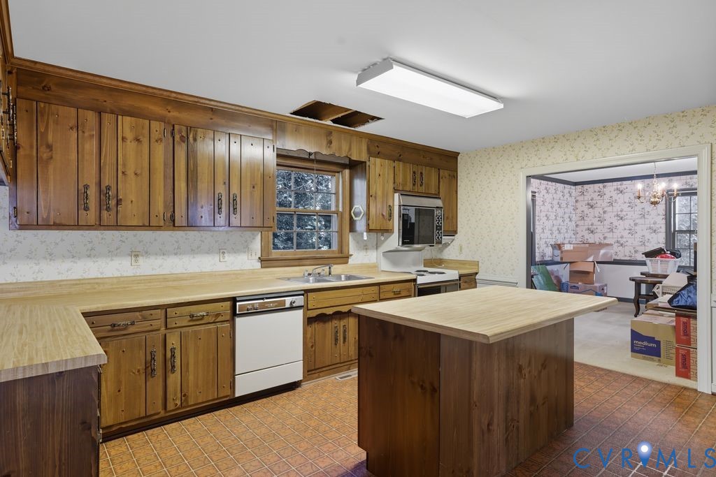 12805 Gloria Court Chester, VA 23831 - Photo 11 of 39 a kitchen with a sink stove and cabinets