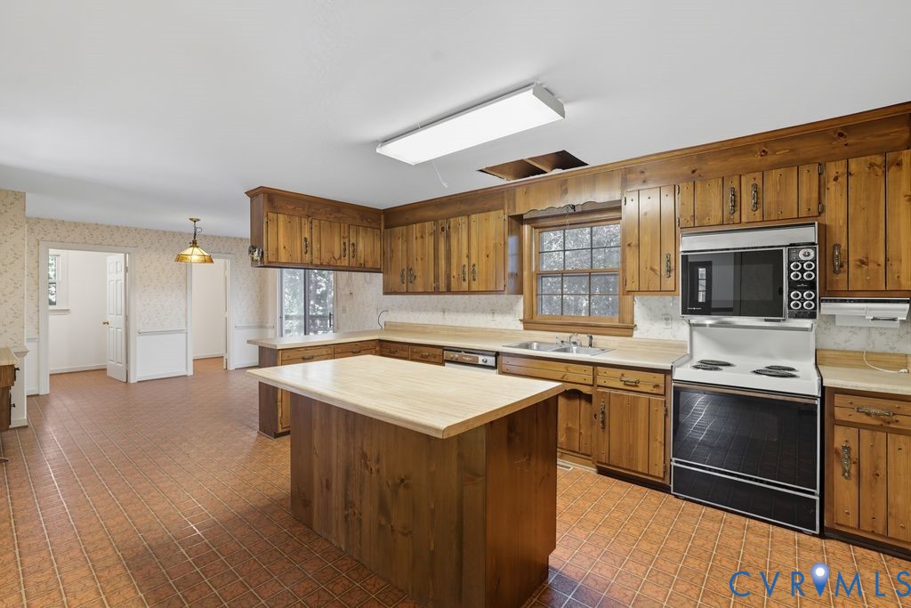 12805 Gloria Court Chester, VA 23831 - Photo 12 of 39 a kitchen with stainless steel appliances granite countertop a sink stove and refrigerator