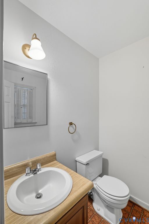 12805 Gloria Court Chester, VA 23831 - Photo 15 of 39 a bathroom with a sink a mirror and a toilet
