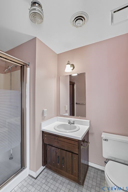 12805 Gloria Court Chester, VA 23831 - Photo 23 of 39 a bathroom with a sink a toilet and mirror