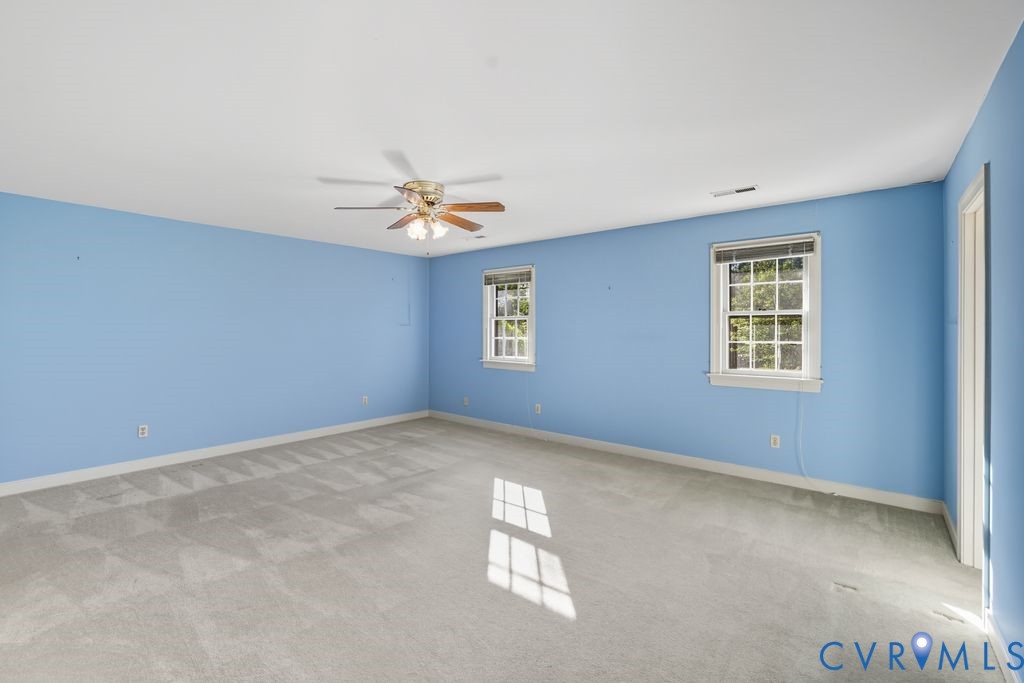 12805 Gloria Court Chester, VA 23831 - Photo 28 of 39 an empty room with windows and chandelier fan