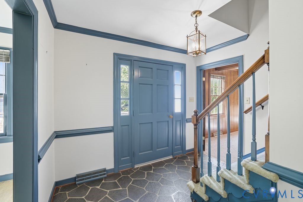 12805 Gloria Court Chester, VA 23831 - Photo 5 of 39 a view of a hallway with wooden floor and staircase