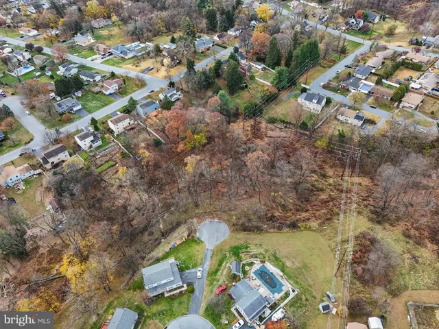 an aerial view of residential house with outdoor space and swimming pool