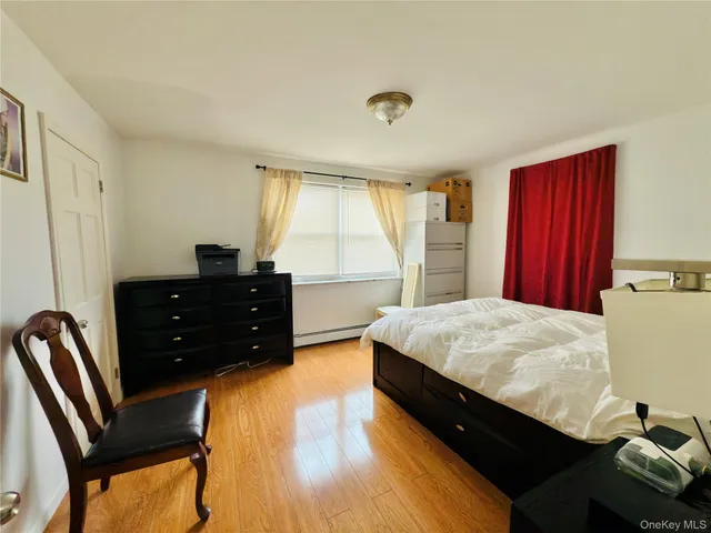 a large bed sitting in a bedroom and dresser
