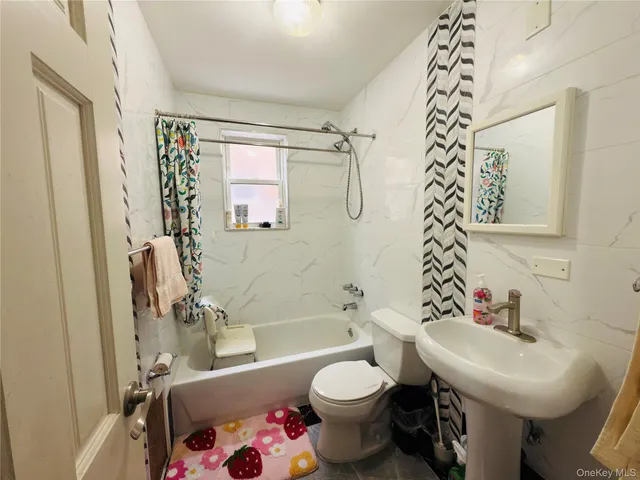 a bathroom with a sink toilet and mirror