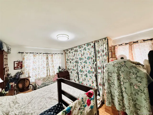 a bedroom with bed and a chandelier