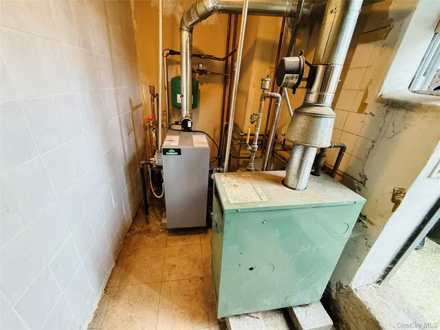 a view of storage and utility room with refrigerator
