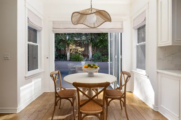 a view of a dining room with furniture window and wooden floor