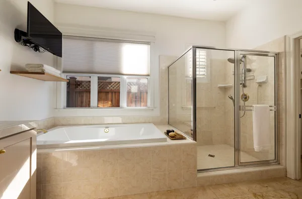 a bathroom with a bathtub and a shower