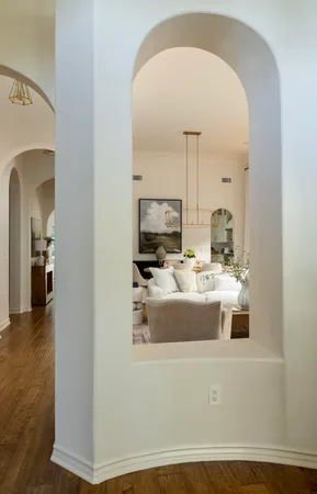 a view of living room with furniture and a mirror