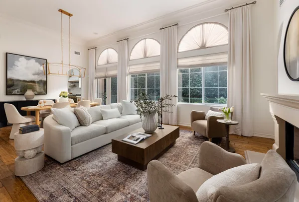 a living room with furniture fireplace and a large window