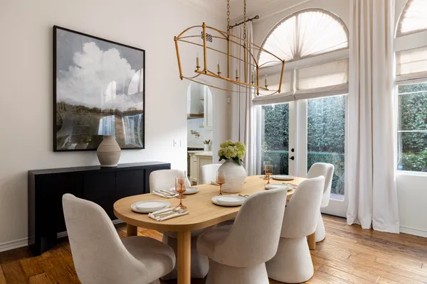 a view of a dining room with furniture large windows and wooden floor