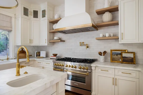 a kitchen with stainless steel appliances granite countertop a sink and a stove