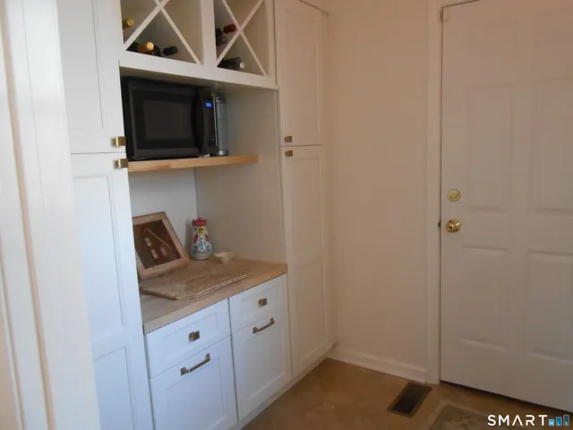 a kitchen with a microwave and cabinets