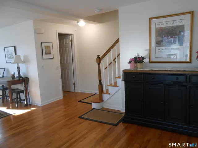 a view of entryway with dining room and wooden floor