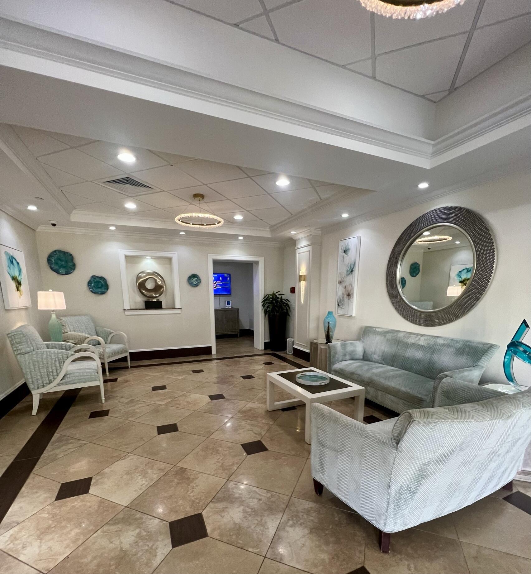 100 Ocean Trail Way, Unit 109 Jupiter, FL 33477 - Photo 22 of 27 a living room with furniture and a mirror