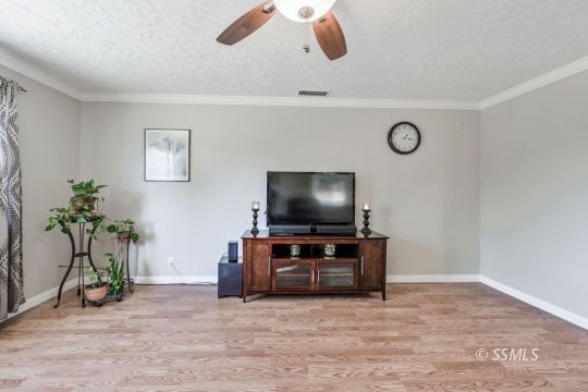 1233 Mayo Street Ridgecrest, CA 93555 - Photo 13 of 32 a living room with furniture and a flat screen tv