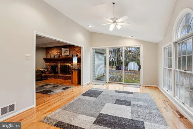 a spacious bedroom with a large bed and a chandelier