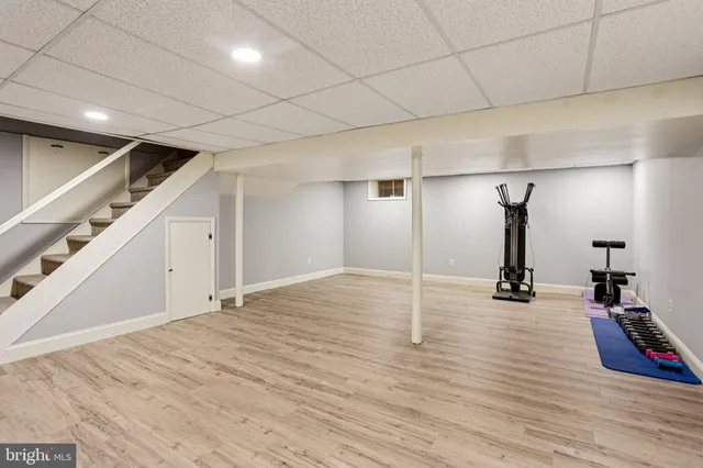 a spacious bedroom with a bed and a ceiling fan