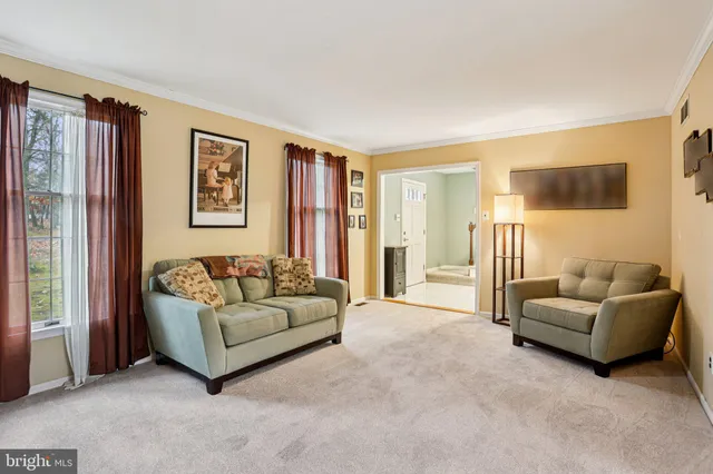 a view of a livingroom with workspace and a window