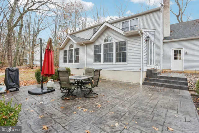 a view of outdoor space with a table and chairs under an umbrella