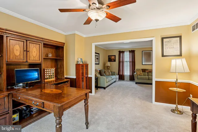 a view of a workspace with furniture and a window
