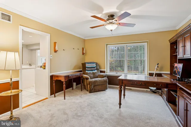a dining room with furniture a chandelier and wooden floor